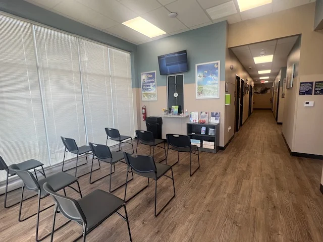 Rows of chairs facing wall-mounted screen and brochures