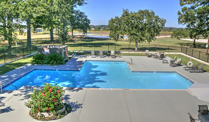 Outdoor pool area with seating.