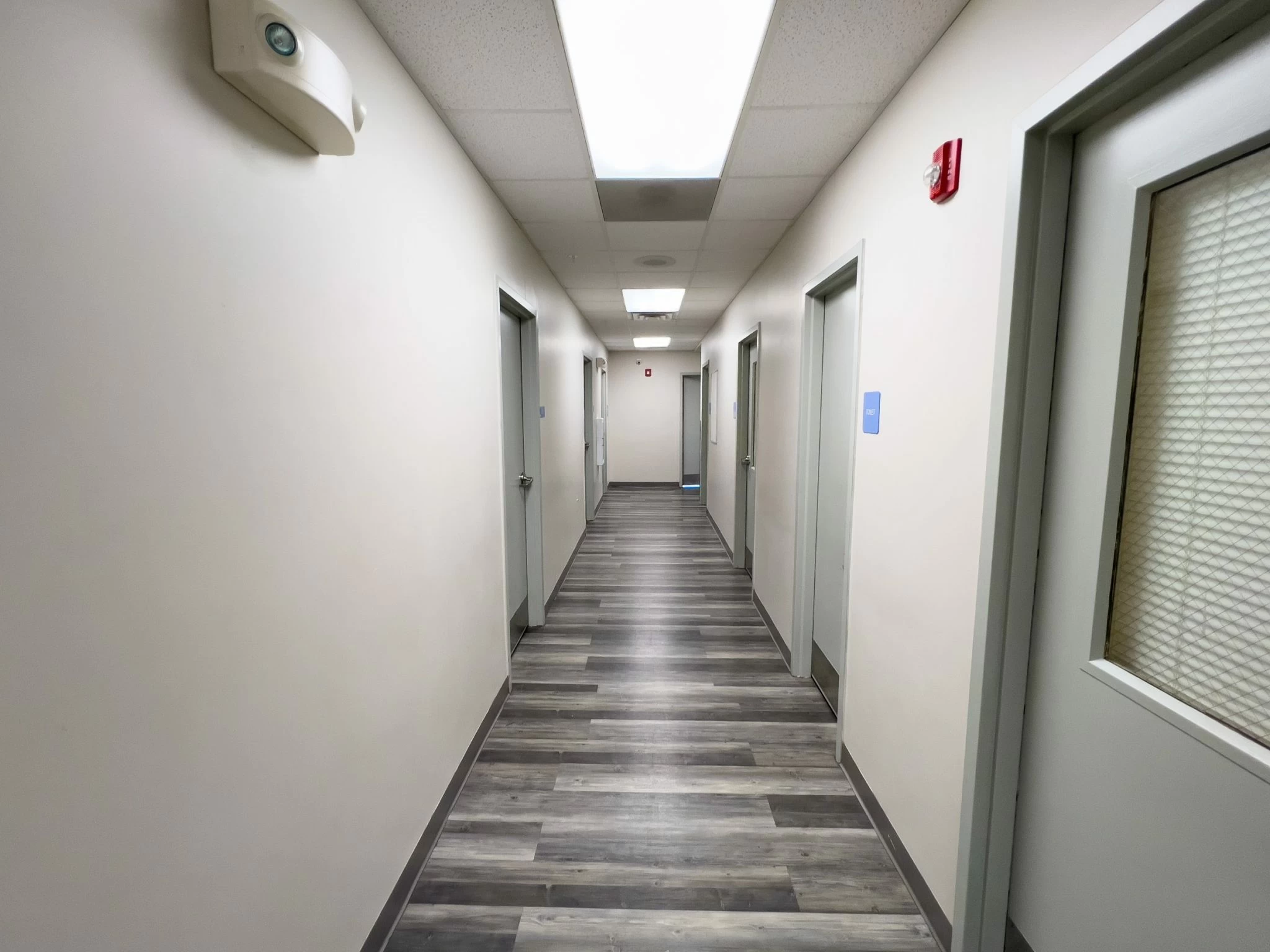 Clean hallway with doors to resident rooms