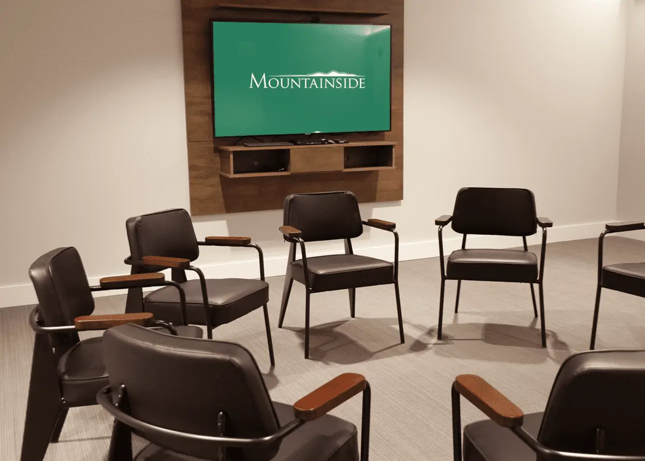Therapy chairs arranged in a circle around a TV screen