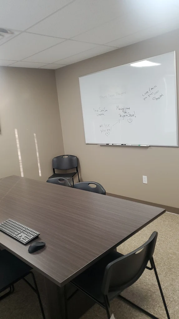 Group counseling room with conference table and whiteboard