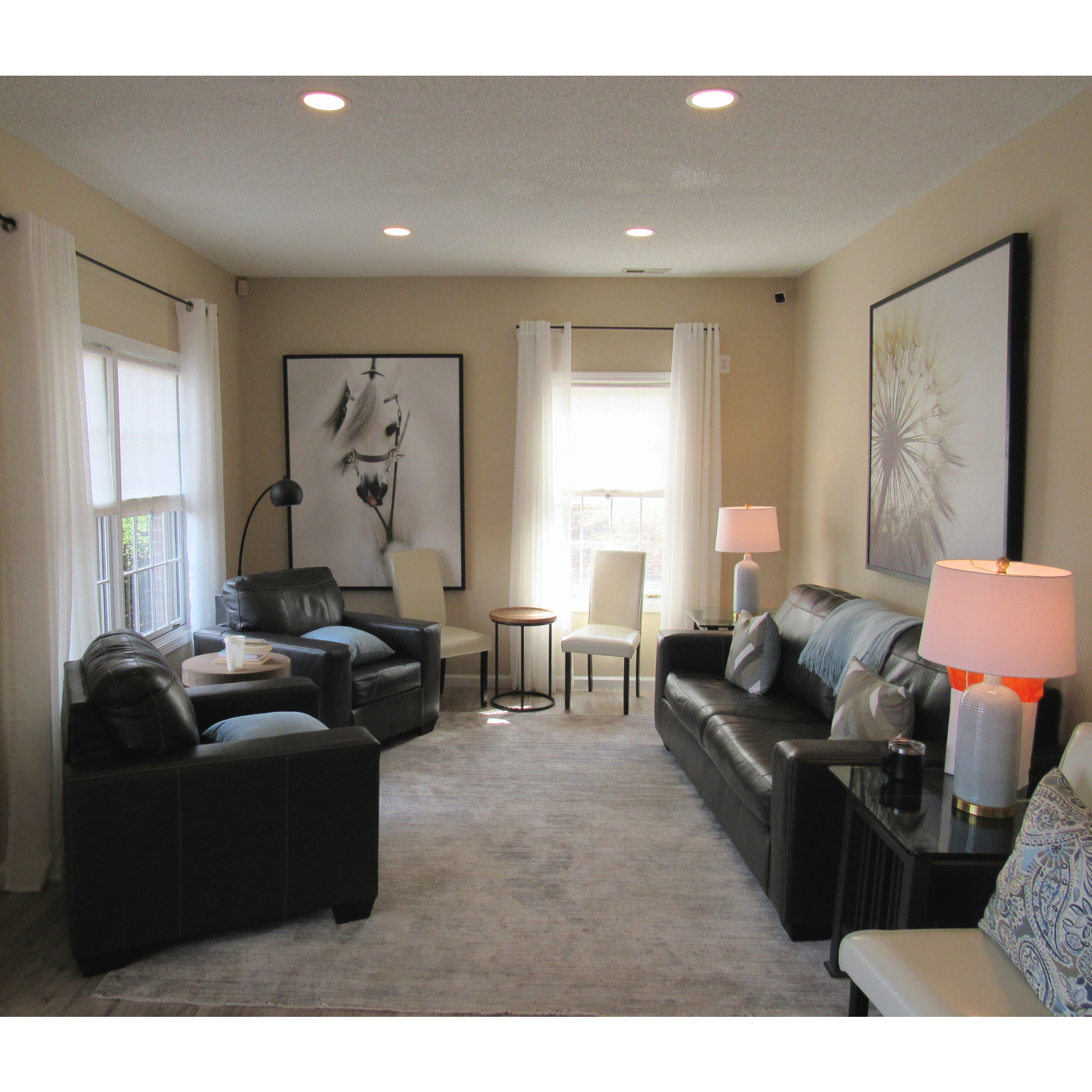 A cozy lounge with leather chairs and soft lighting