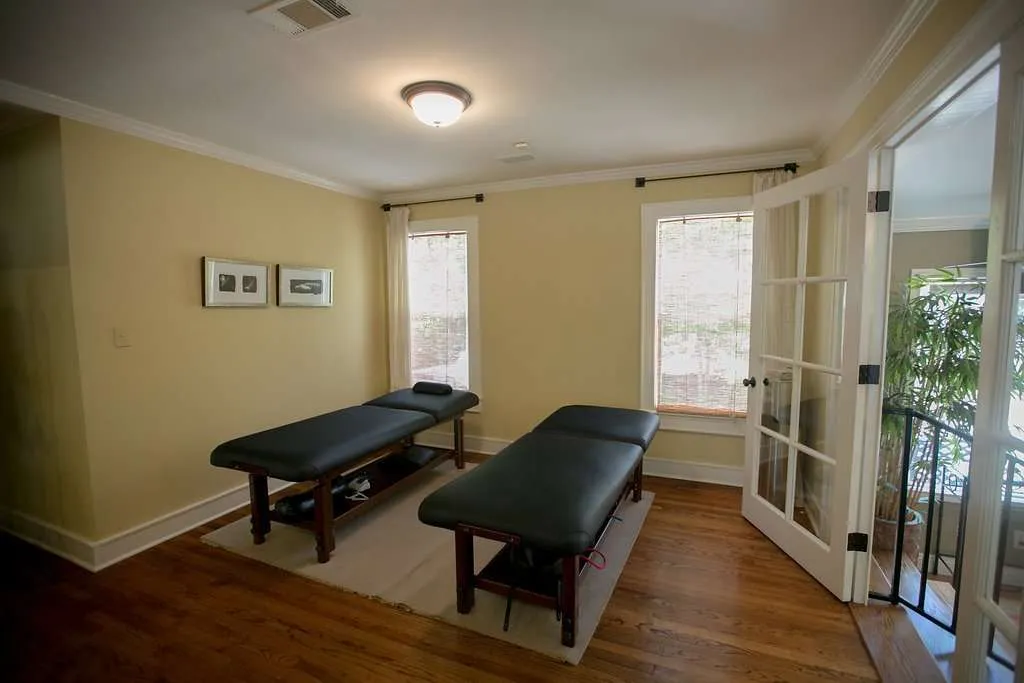 Two massage tables near bright windows