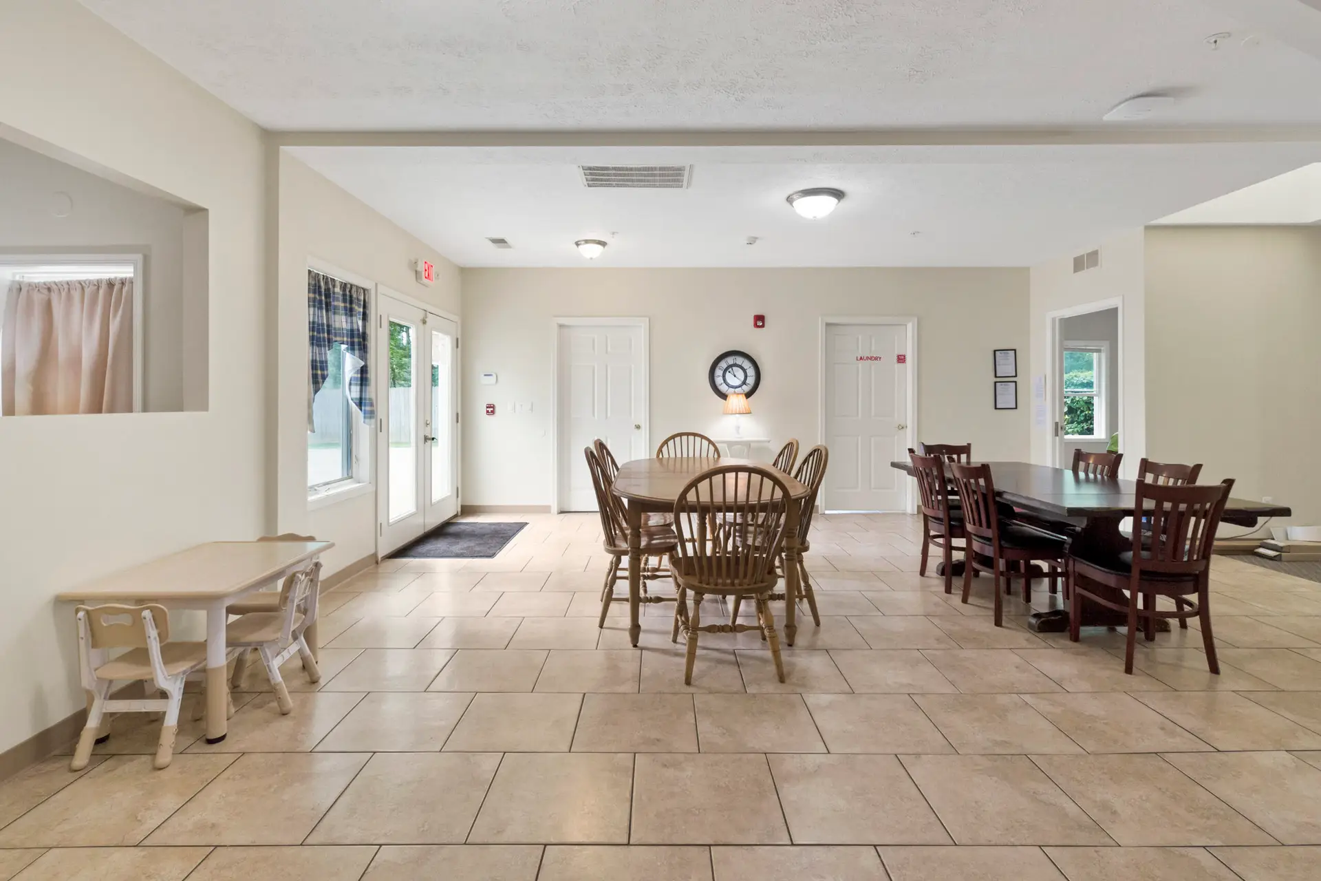 Communal dining room with multiple tables and chairs
