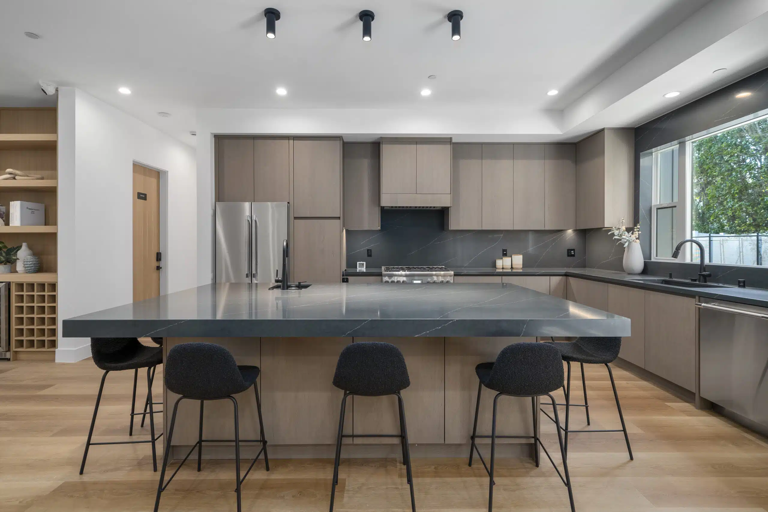 Sleek kitchen with island seating and stainless appliances