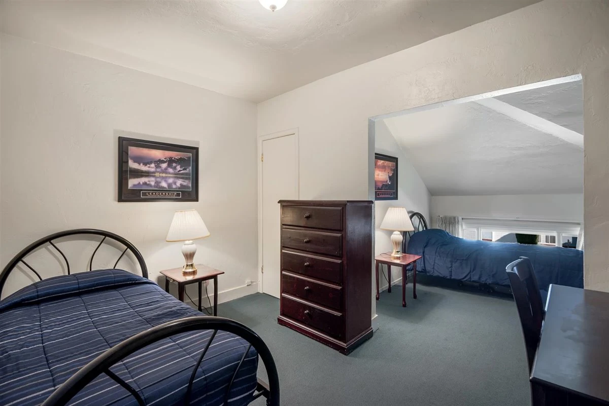 Shared rehab bedroom with twin beds and dresser.