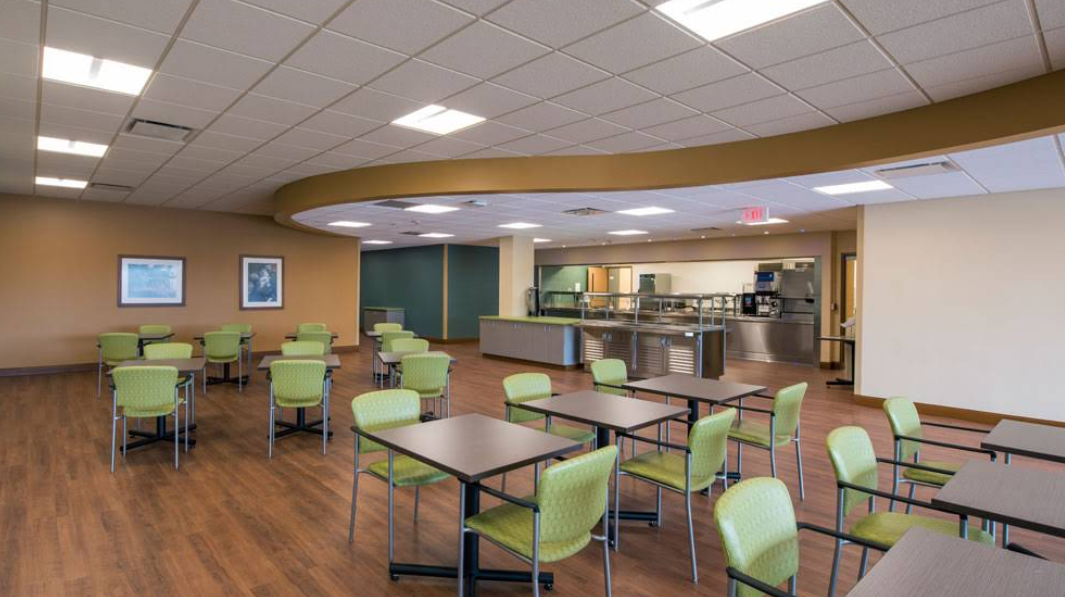 Dining area with tables, chairs, and cafeteria counter