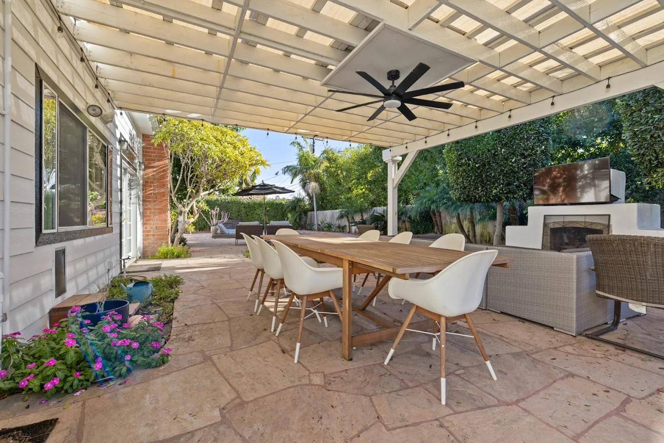 Covered patio with dining table and fireplace