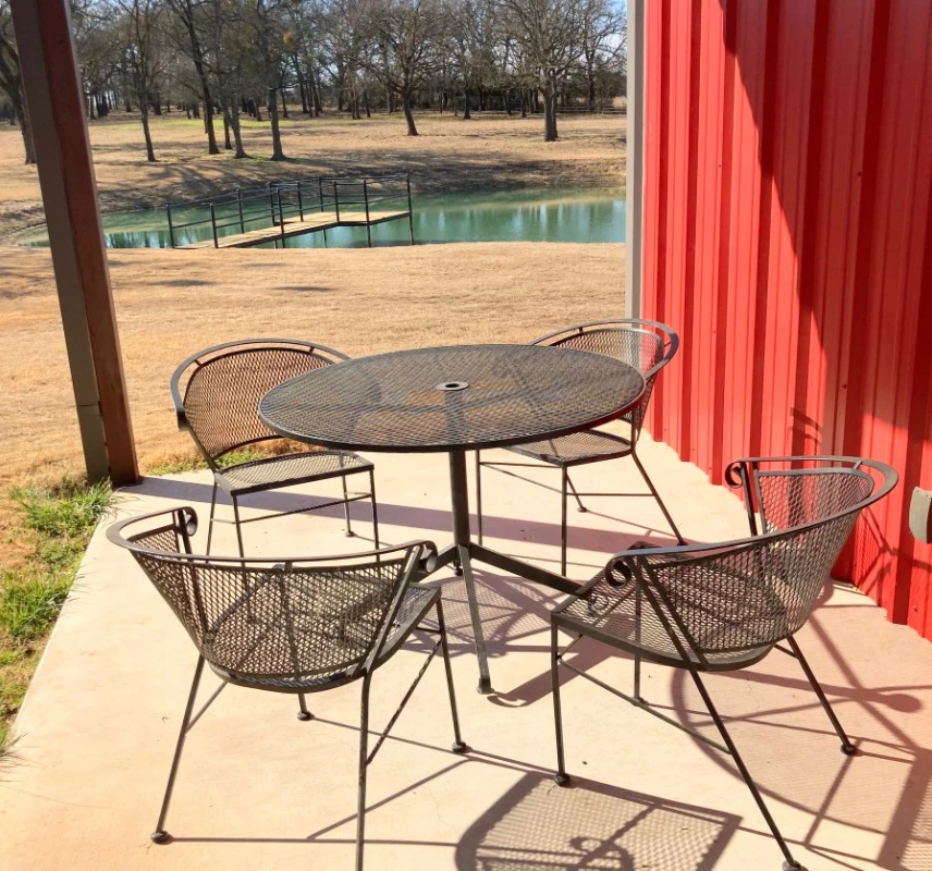 Outdoor table with chairs near red building