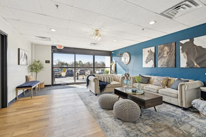 Inviting lobby with cozy sofas and horse artwork