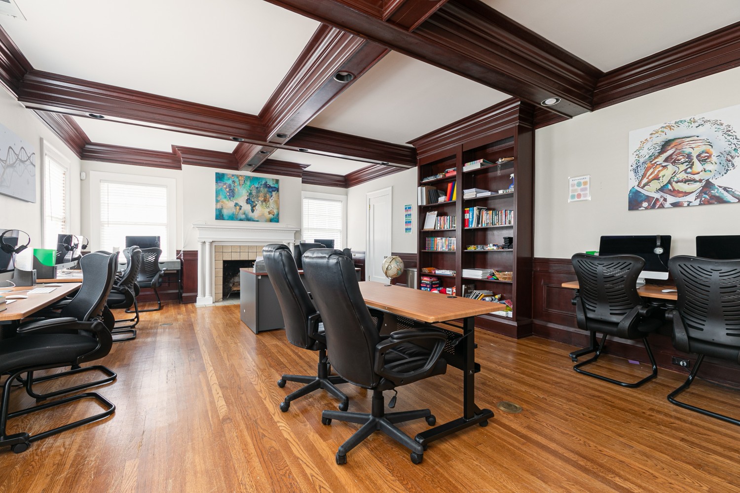 Shared office with computers and dark wood decor