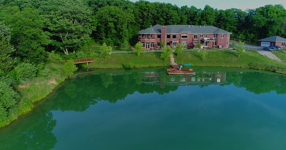 Lakeside view of the ranch with treatment buildings nearby