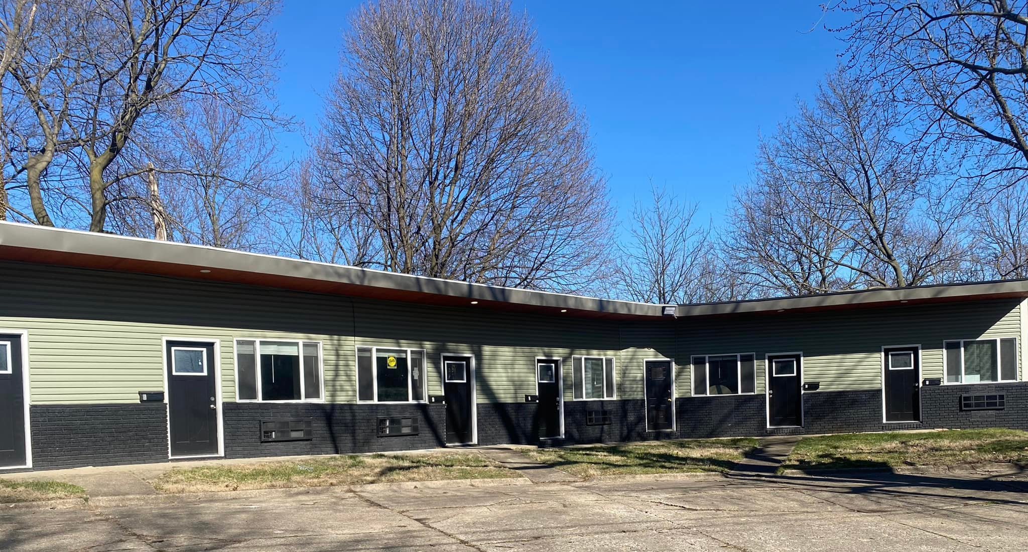 One-story green building with multiple units