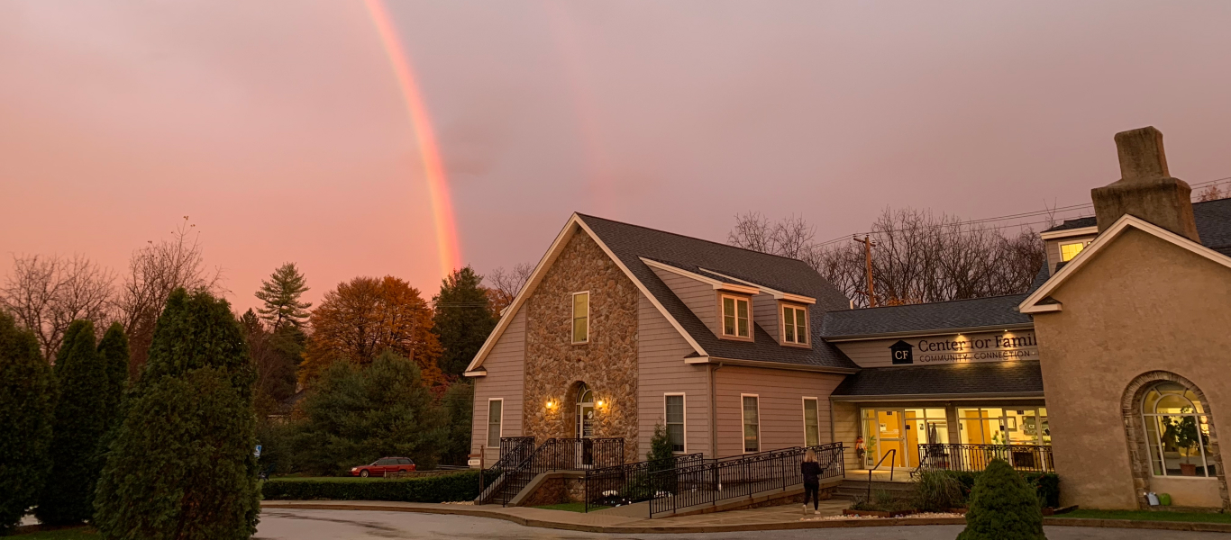 A cozy therapy room with a sofa, chairs, and a coffee table.