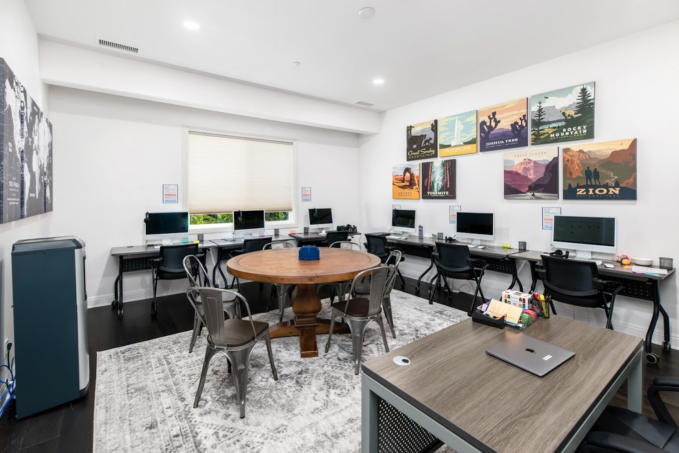 Computer room with chairs paired to desktops.