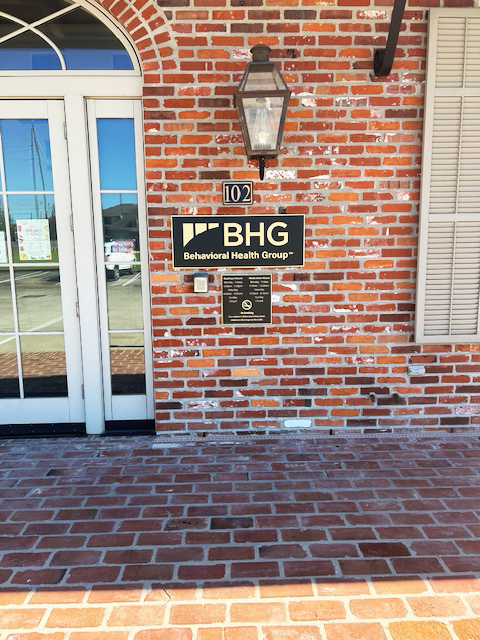 BHG entrance sign mounted on brick exterior wall
