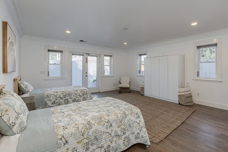 Spacious bedroom with two beds and natural light