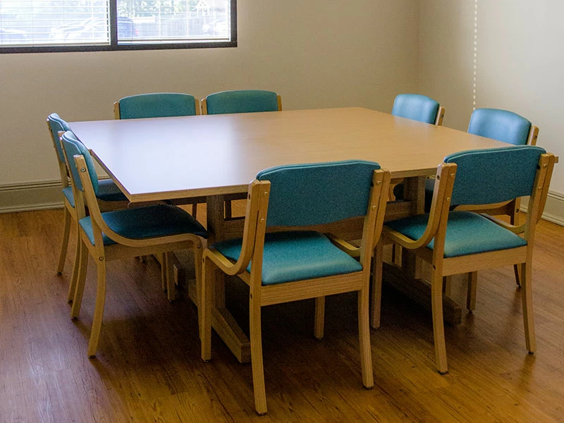 Group therapy room with table seating for counseling sessions