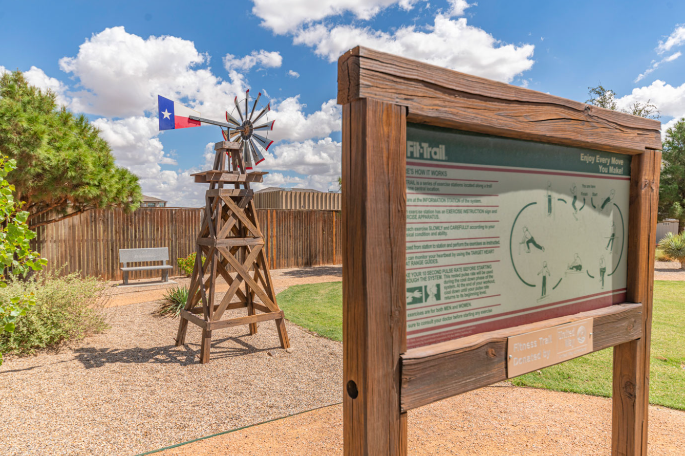 Outdoor fitness trail with windmill and exercise signage