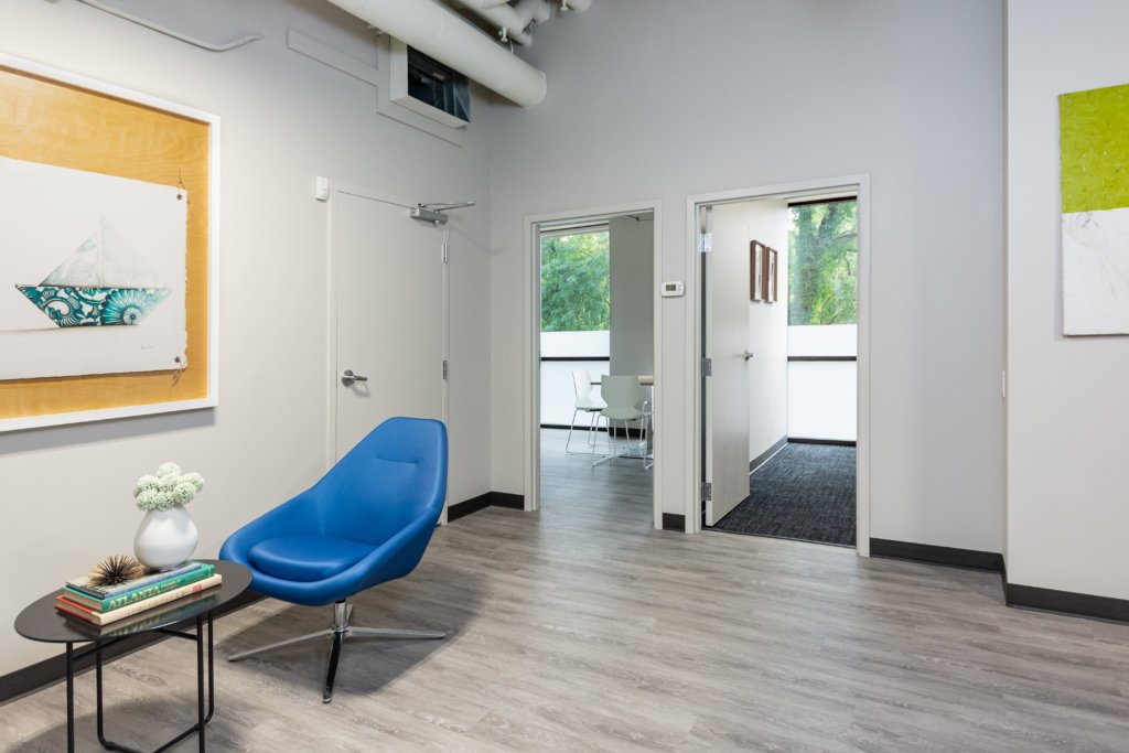 A waiting area with a blue chair and modern decor.