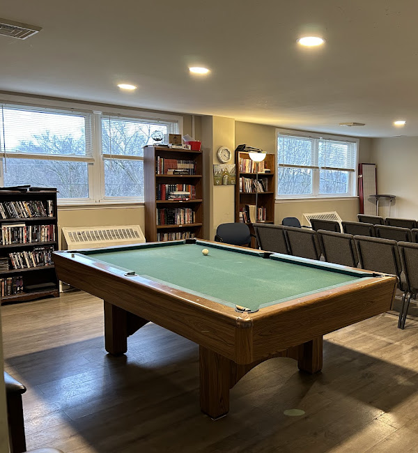 Pool table and bookshelves in lounge-style room