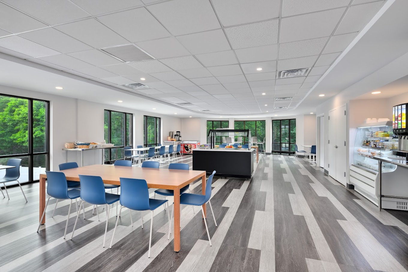A modern cafeteria with large windows and seating.