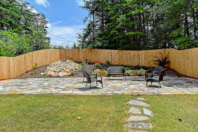 Outdoor common area with seating and stone paving.