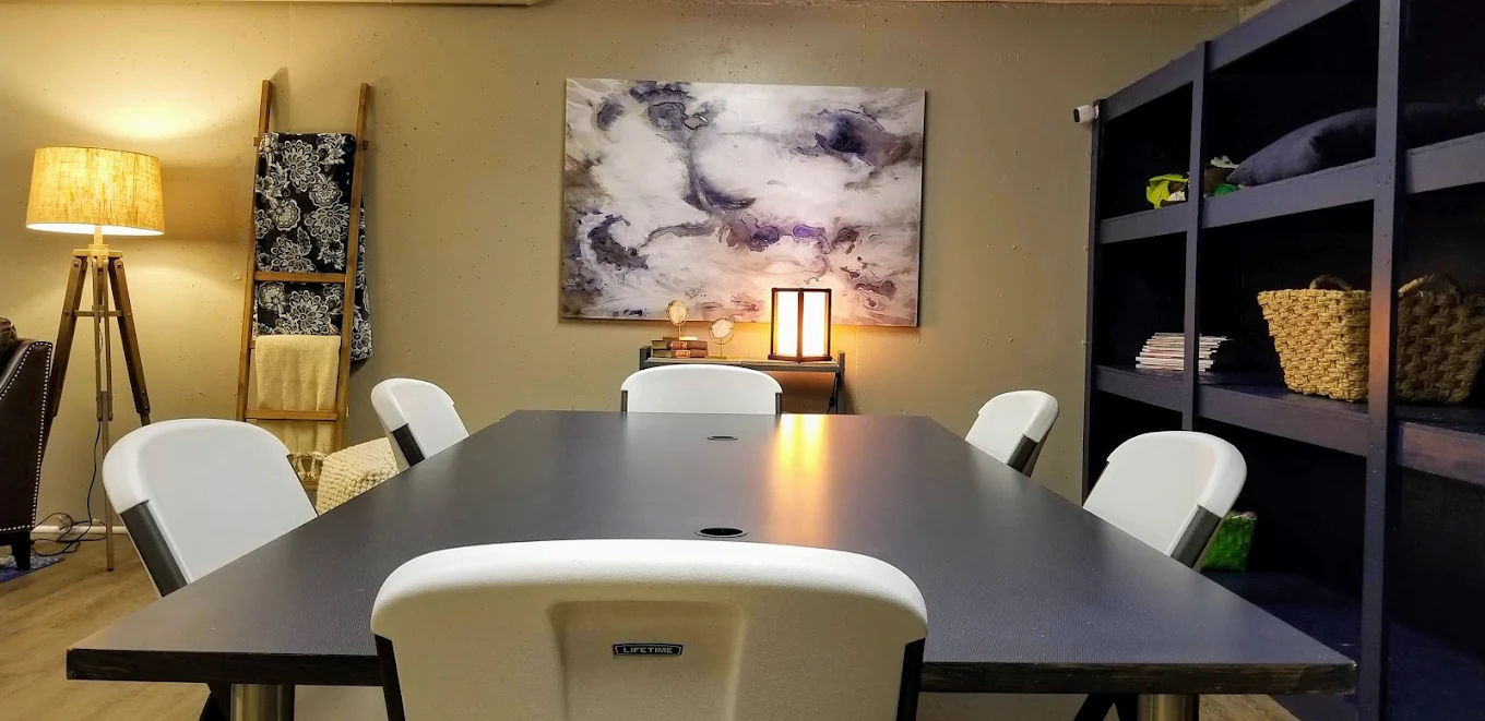 Table with white chairs and wall decor