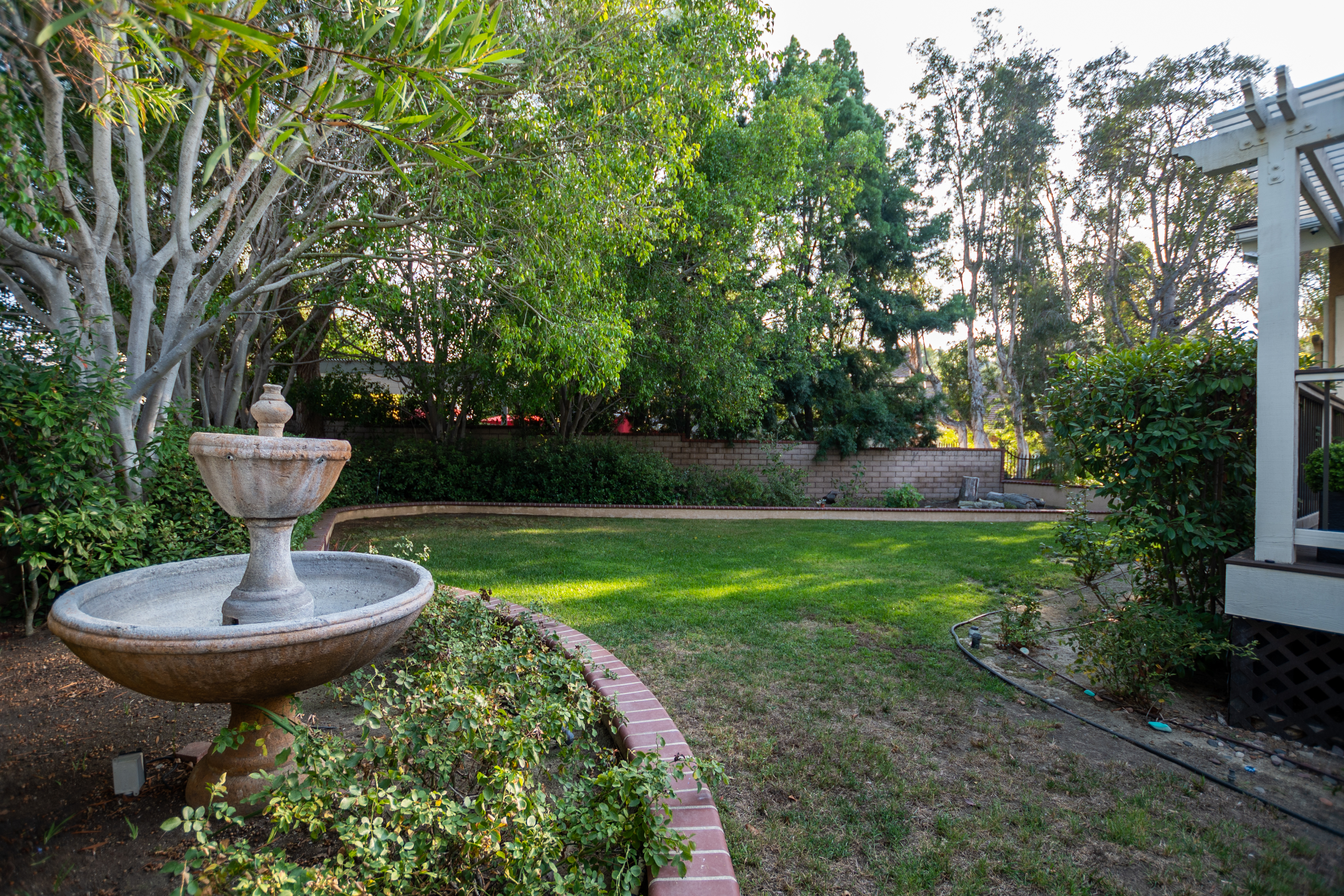 Serene garden with fountain and brick border