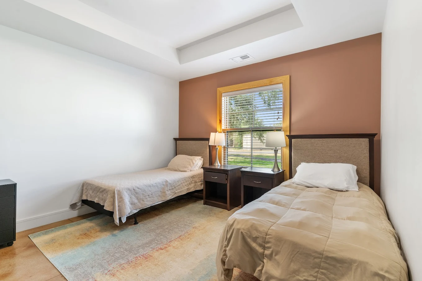 Bedroom with two beds and shared nightstand