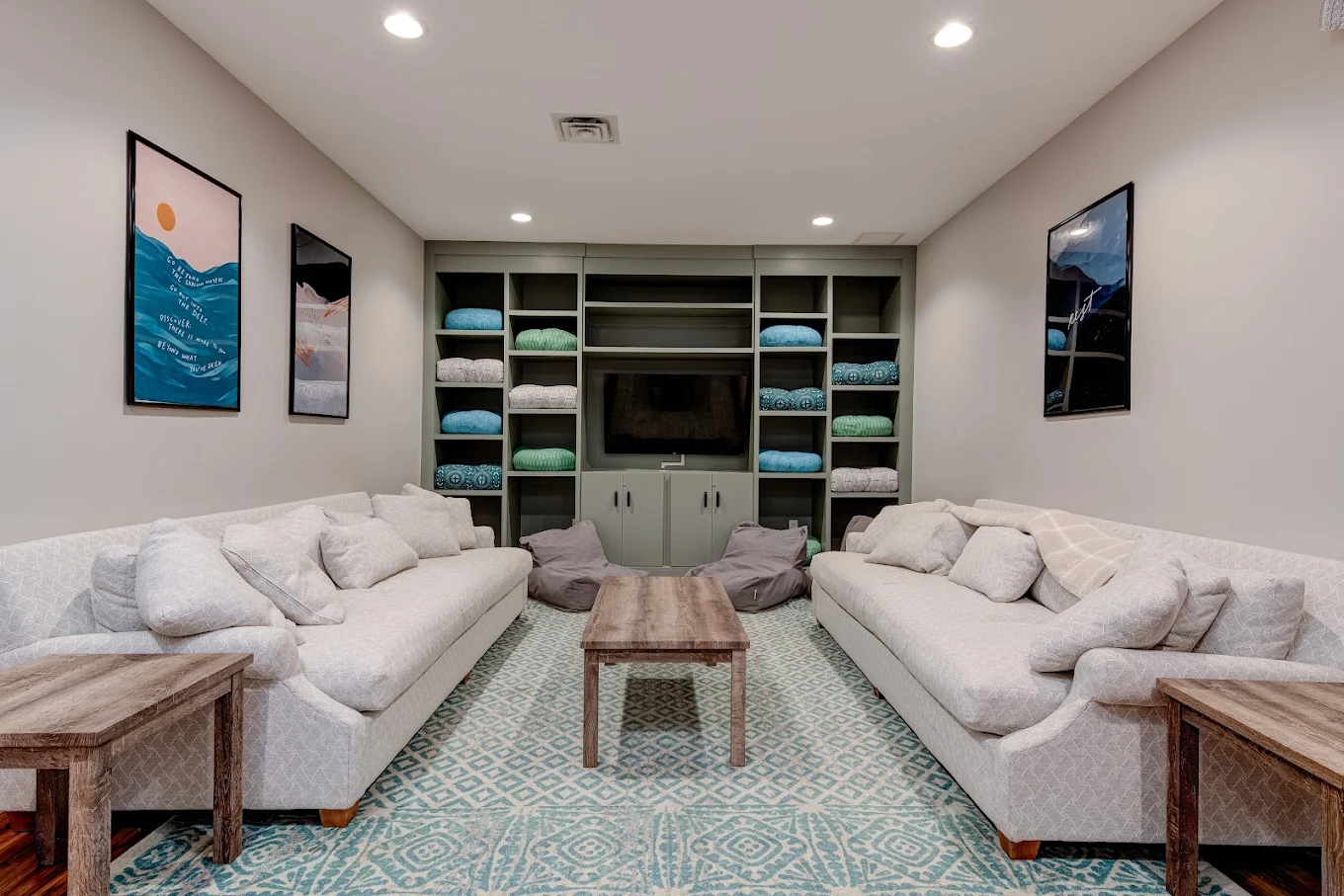 Comfortable lounge with sofas, television and built-in shelving