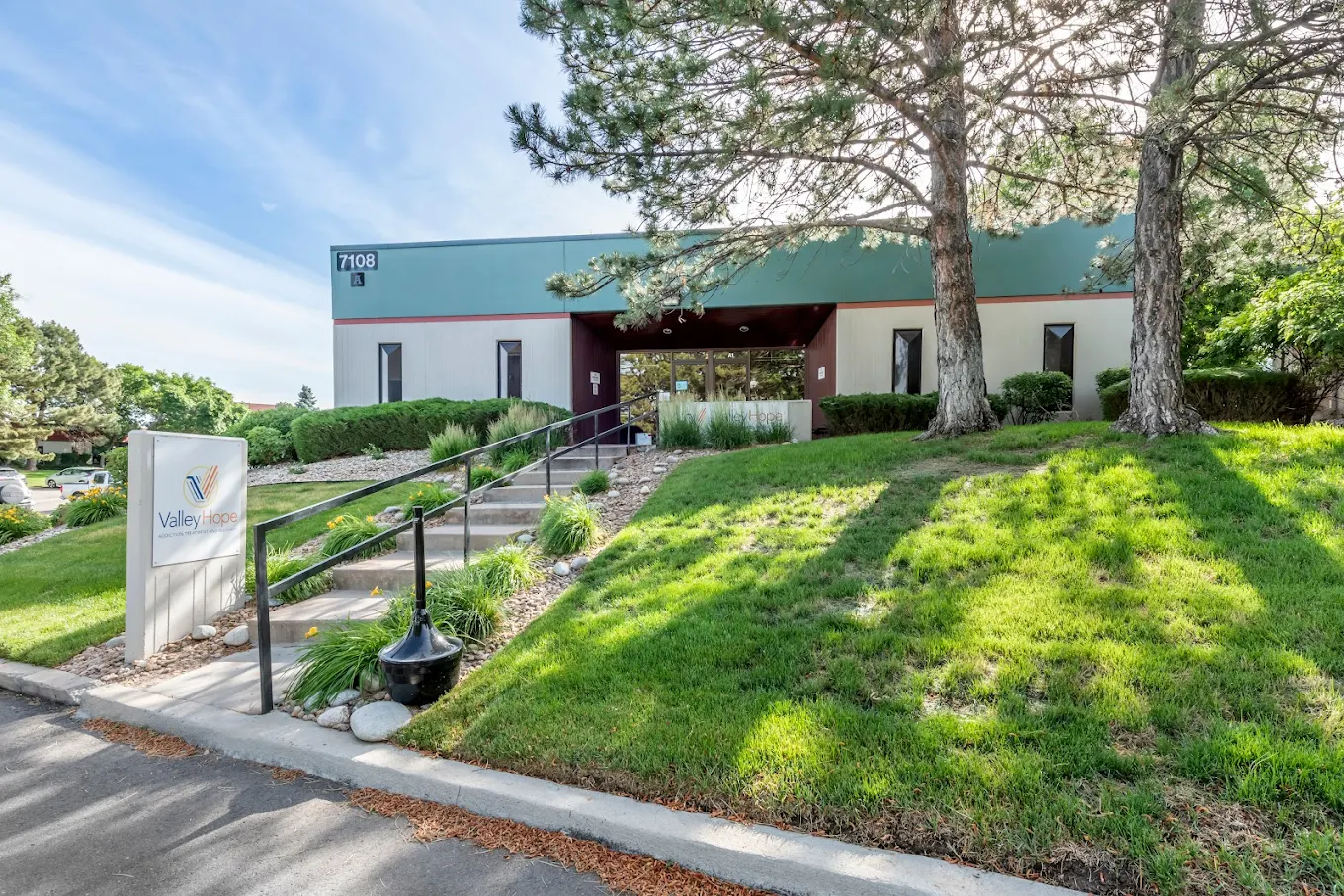 Exterior of rehab facility with landscaping and entry path
