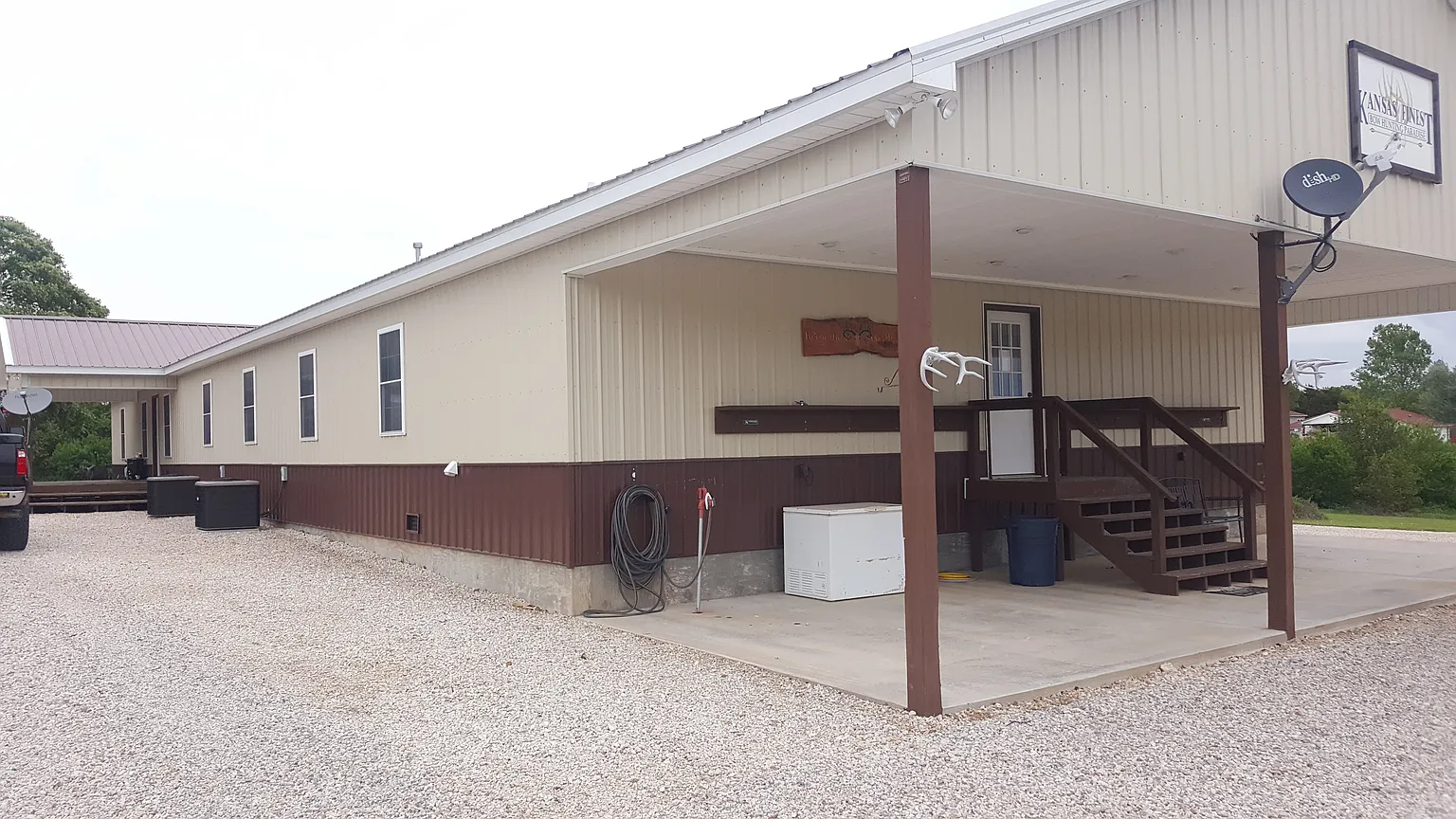 Rear of Kisa Life Recovery Sedan, showcasing a large backyard and a covered porch area for outdoor activities.