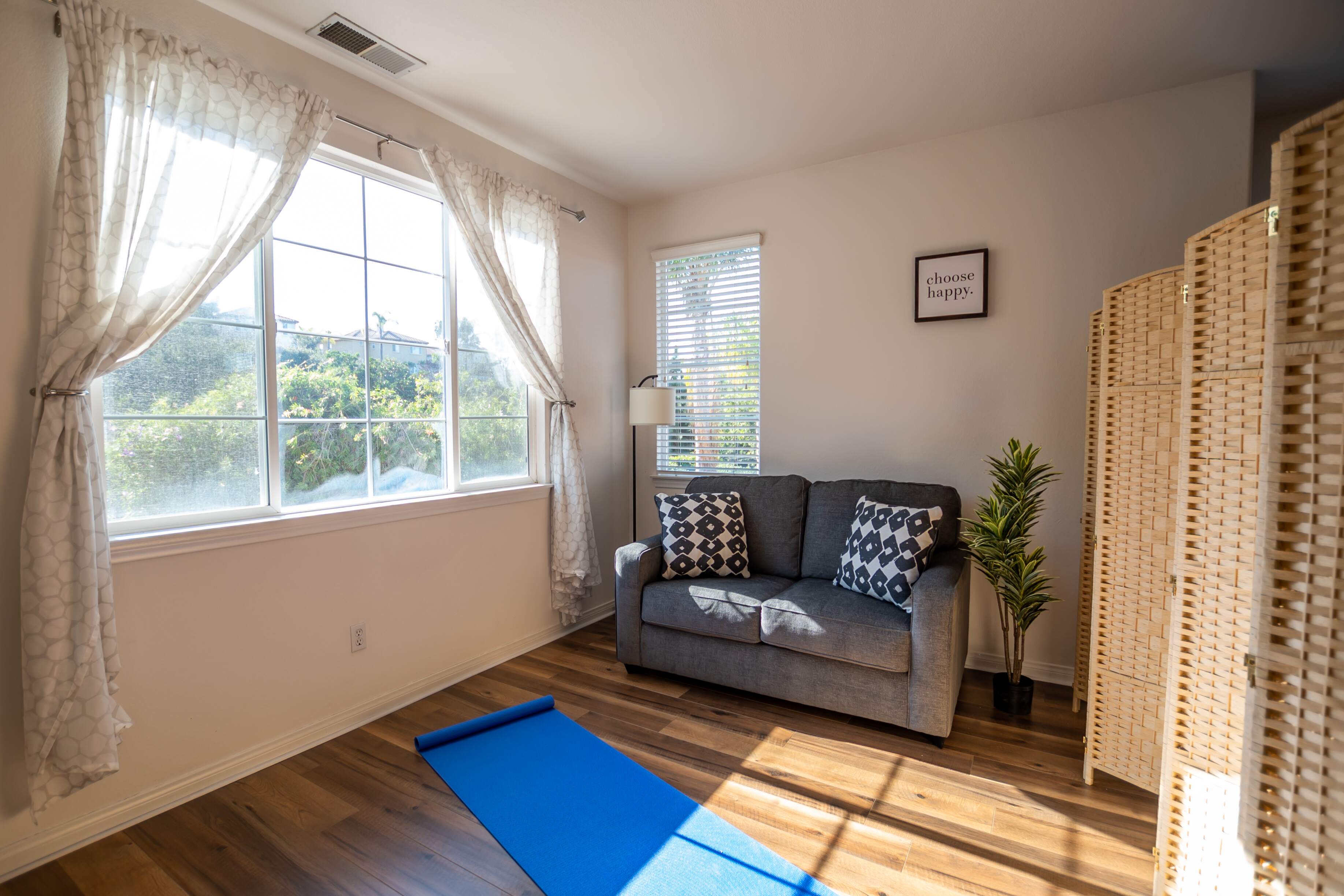 Bright room with yoga mat and a small couch