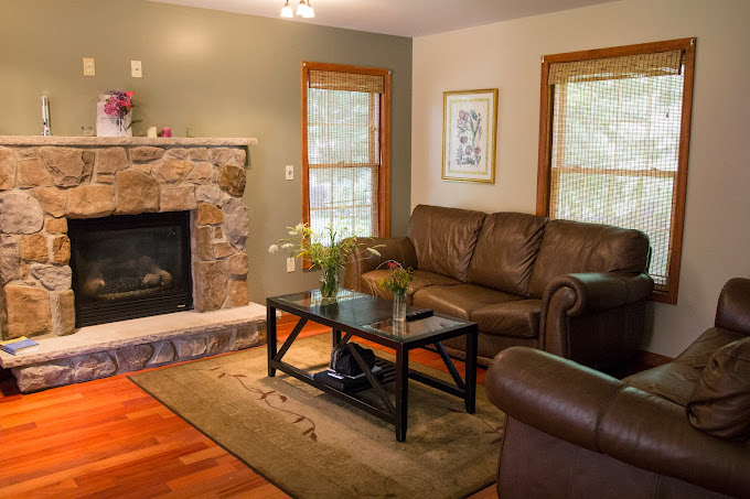 Living room with sofas, table and a fireplace