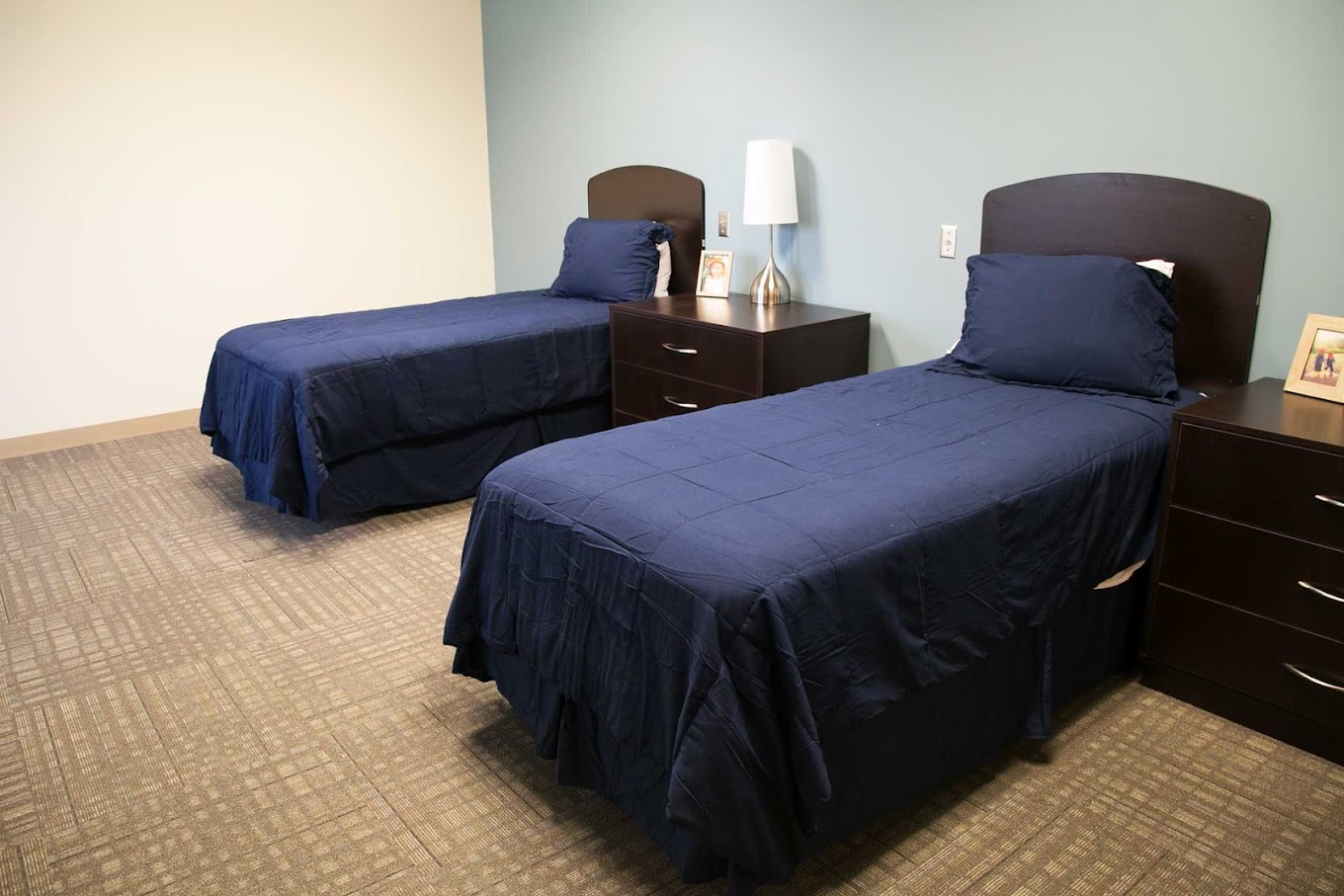 Two twin beds with nightstands in a shared room