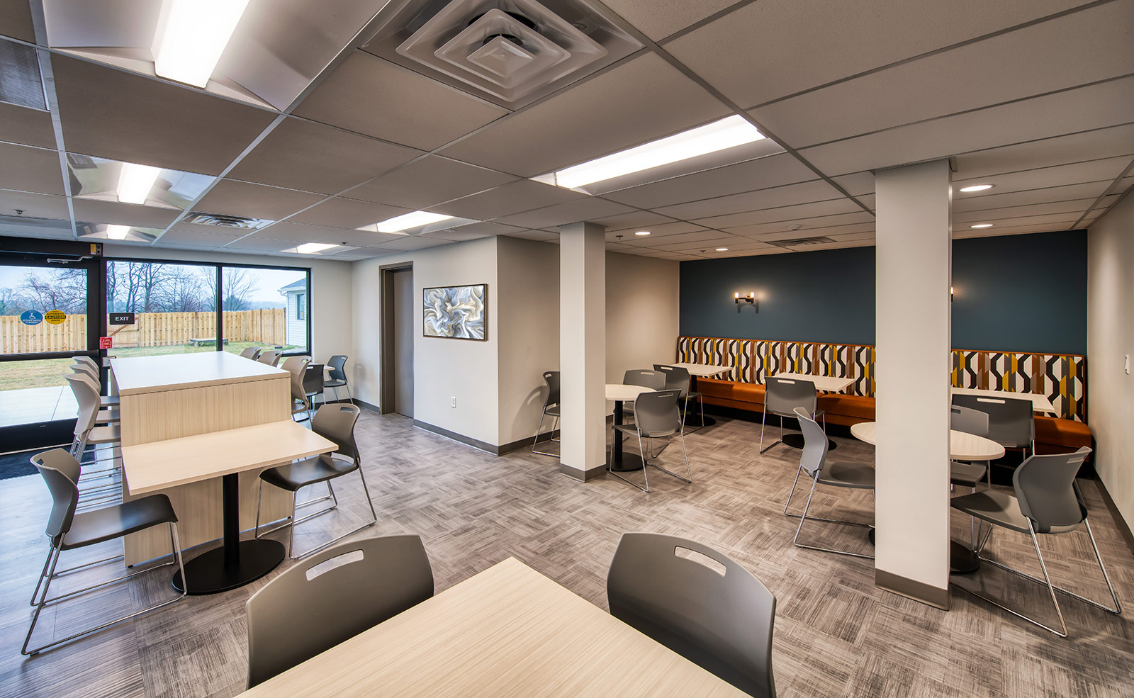 Dining tables near windows and lounge seating