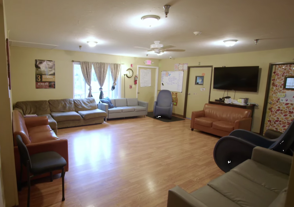 Room with couches and a TV for group meetings
