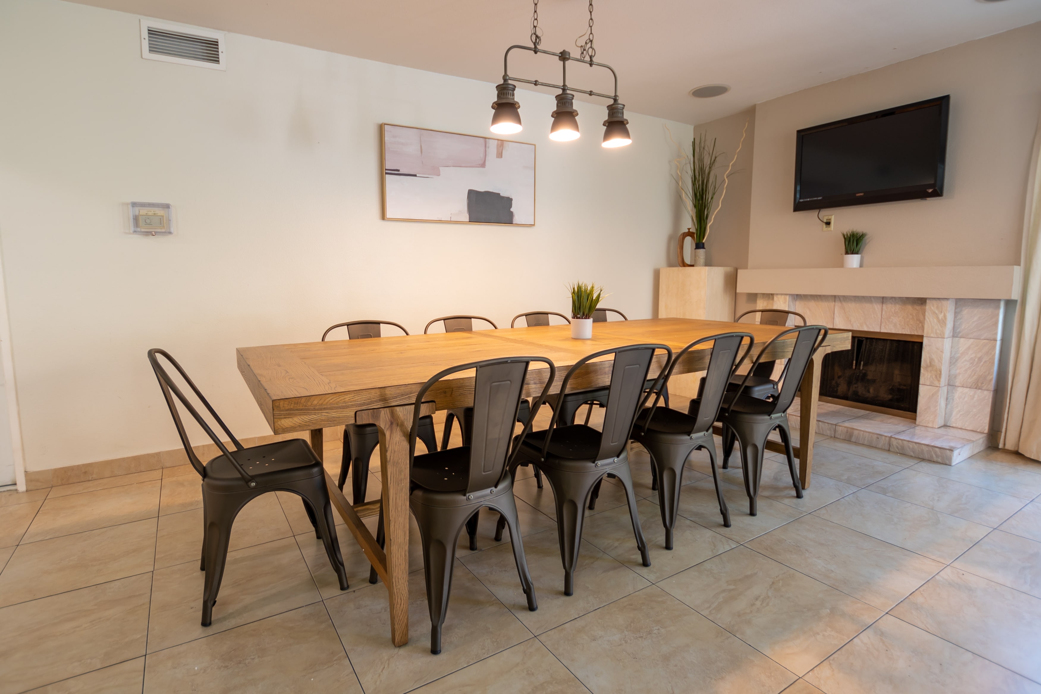 Long wooden table with black chairs in dining room