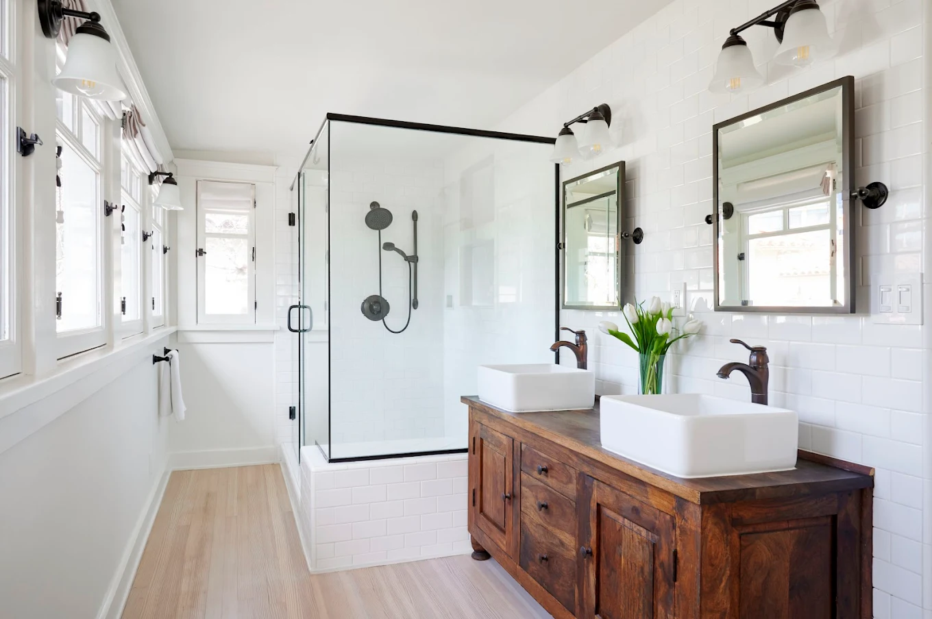 Bright bathroom with glass shower and double sinks