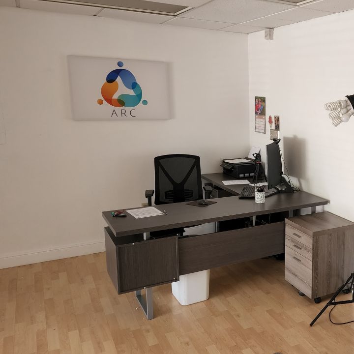 Office space with desk and signage.