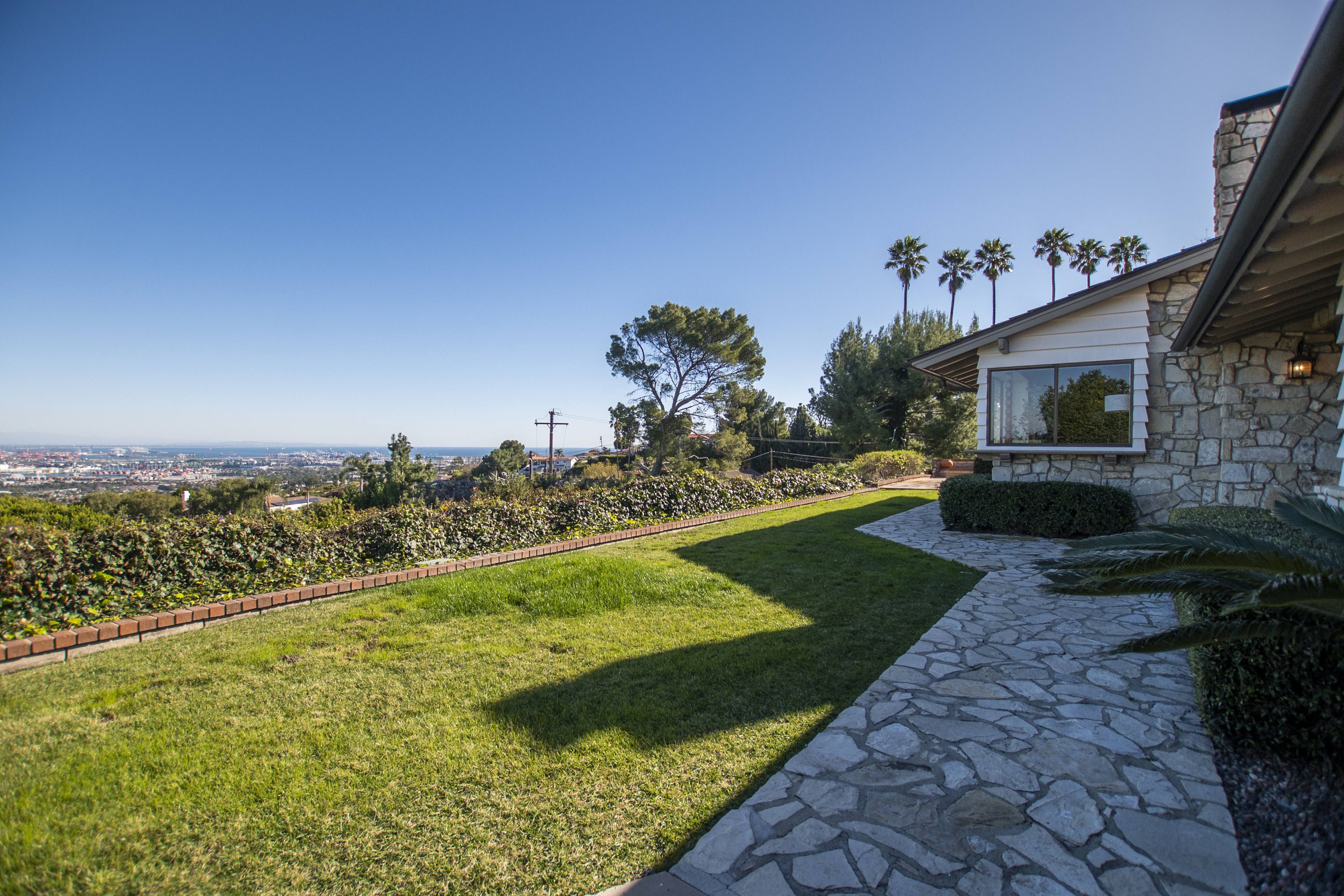 Manicured lawn with a city view from a hillside yard