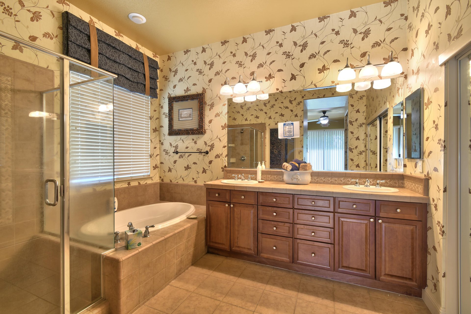 Dual-sink vanity with soaking tub and glass shower