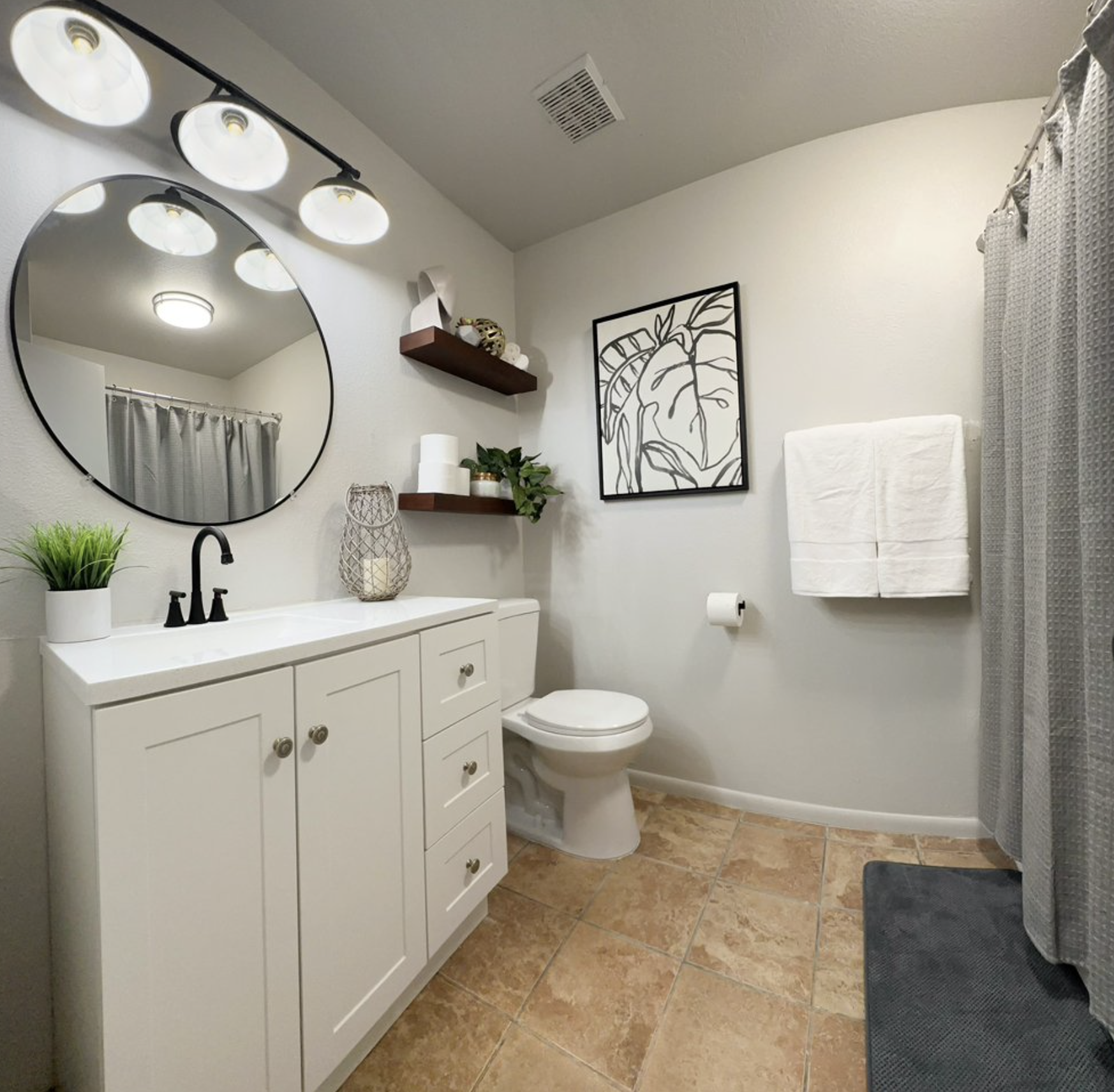 Bathroom with tiled floor and sink, with decor.