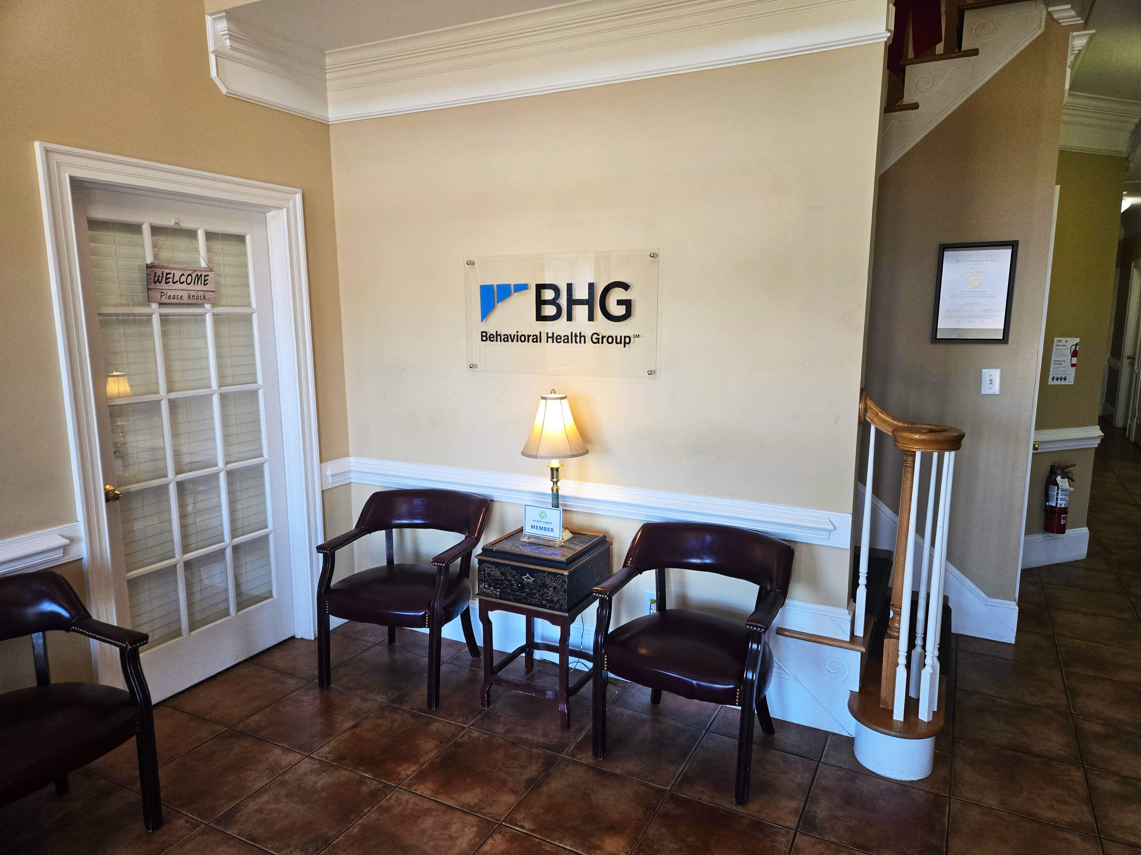 Reception waiting area with chairs and side table