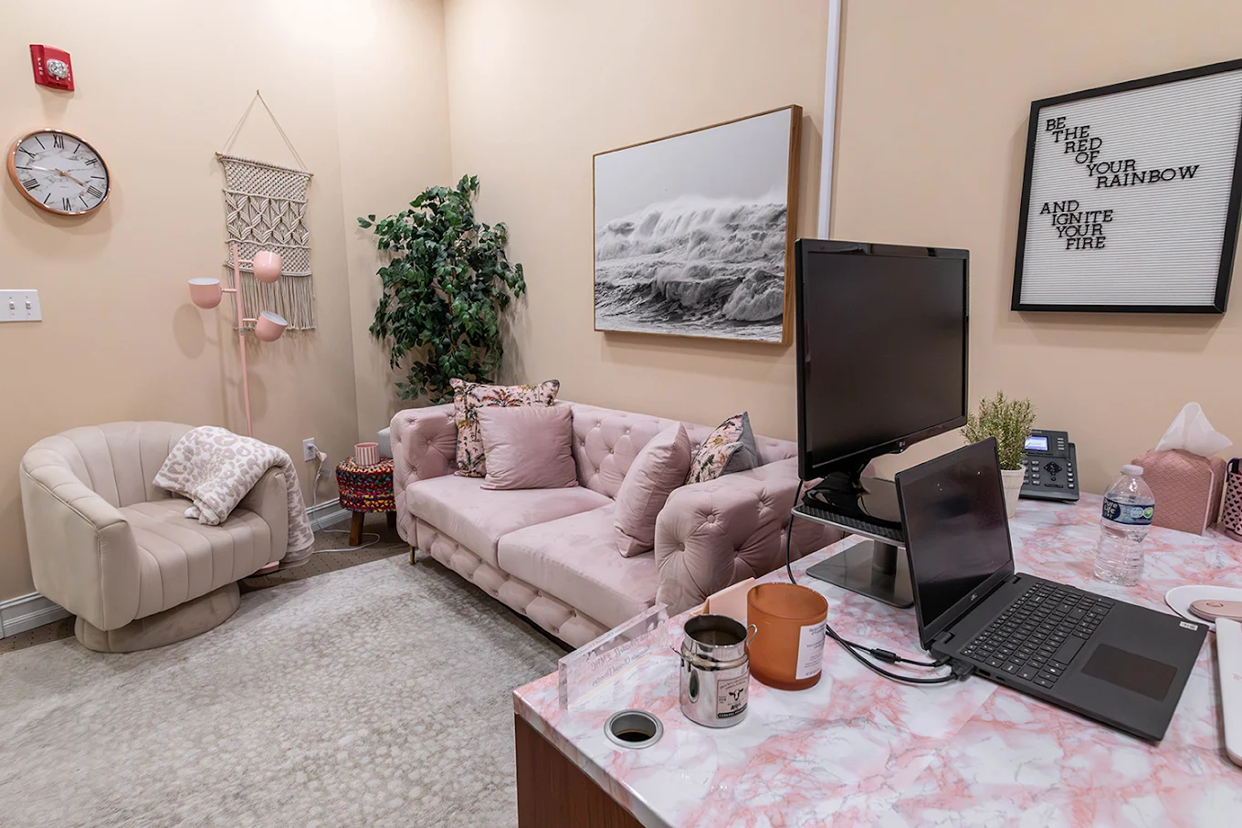 Soft pink sofa and chair in warmly lit therapy office