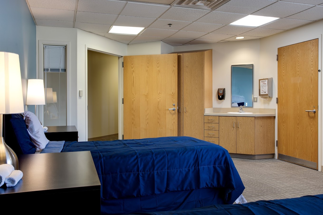 Private room with a single bed and en-suite sink