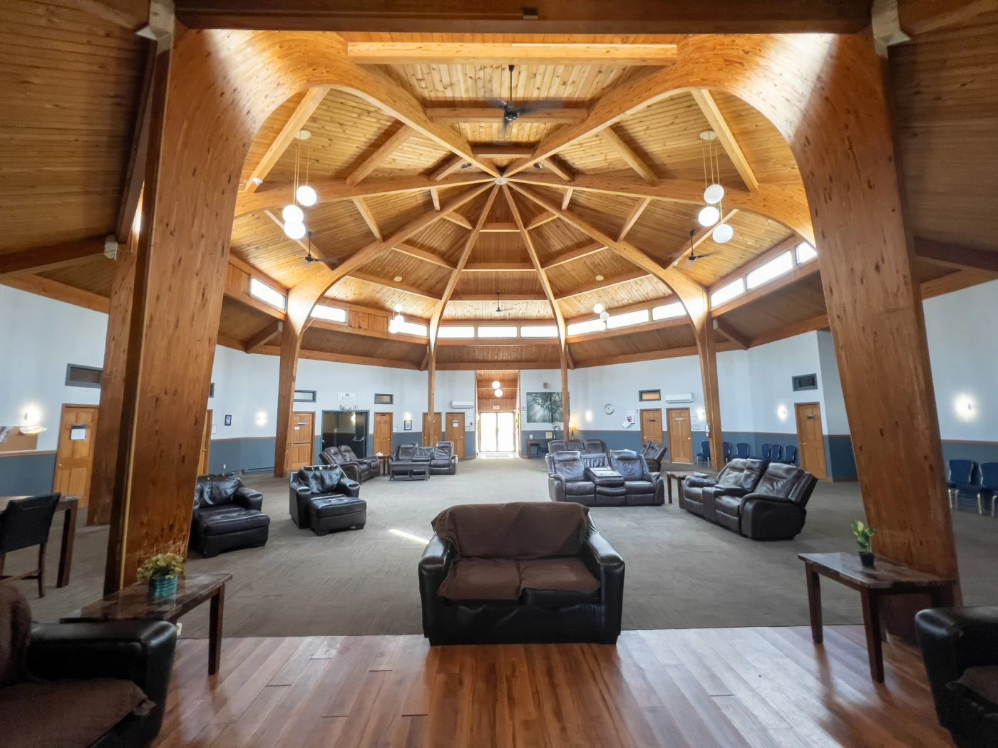 Large wood-beamed lobby with couches and chairs