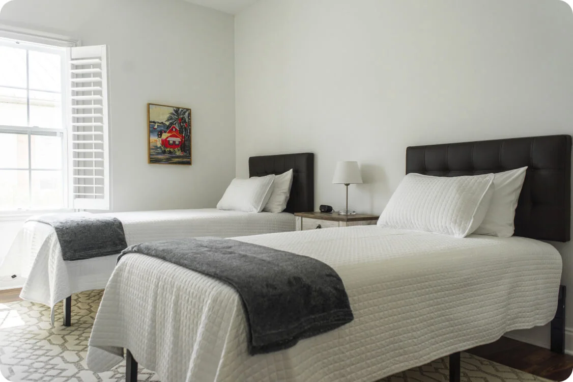 Minimalist bedroom with two white beds