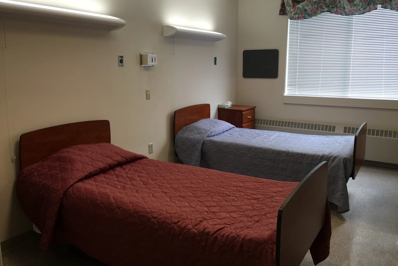 Shared bedroom with two twin beds and bedside tables